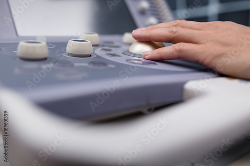 medical equipment background, close-up ultrasound machine and hand of medical doctor. Concept
