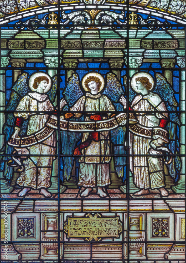 LONDON, GREAT BRITAIN - SEPTEMBER 15, 2017: The angels with the inscription on the satined glass of St James's Church, Clerkenwell by T. F. Ward and Hughes manufacturers (1898).
