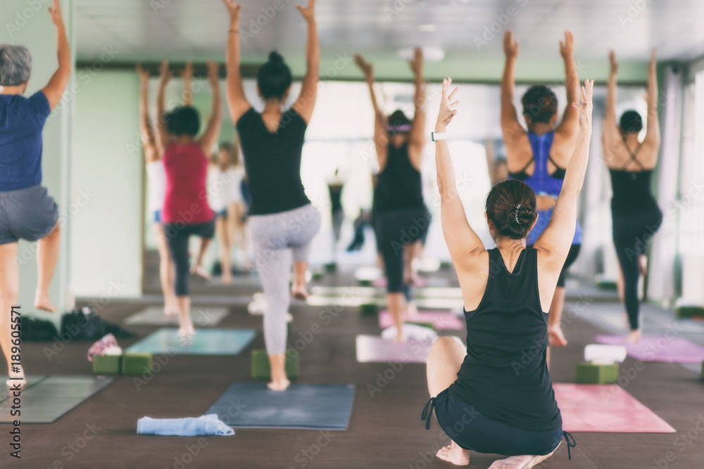 Women asian exercising in fitness studio yoga classes