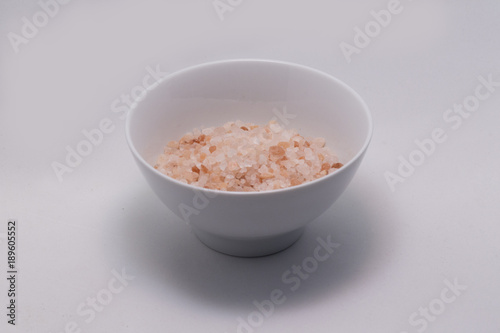 Himalayan salt in white bowl on white background isolated. Healthy lifestyle. 