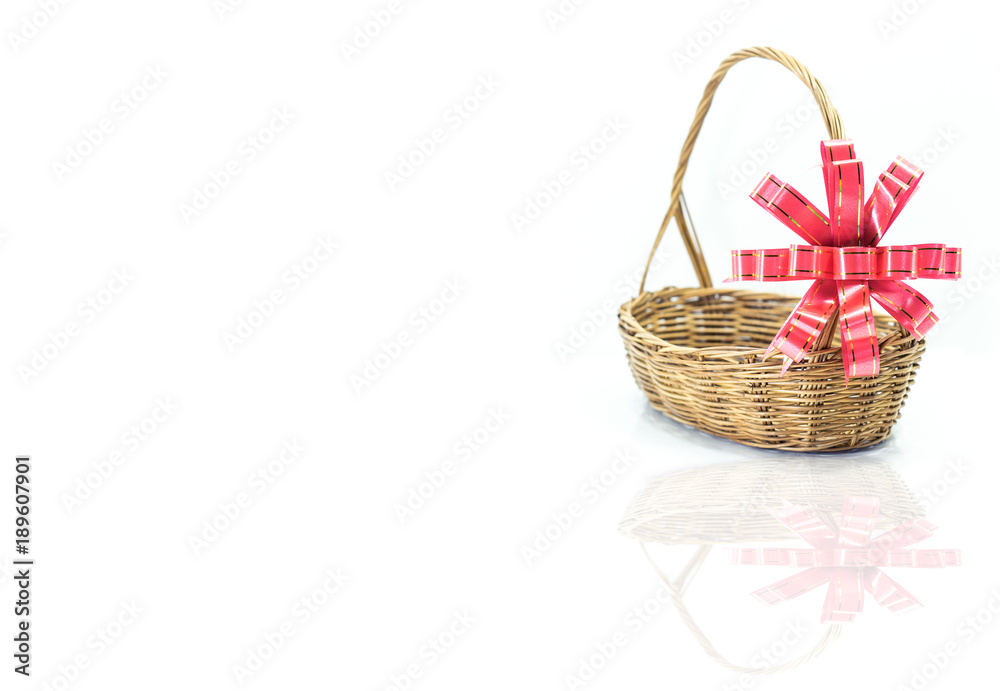 Empty wicker basket with red and gold ribbon isolated on white background Empty wicker basket with red and gold ribbon isolated on white background