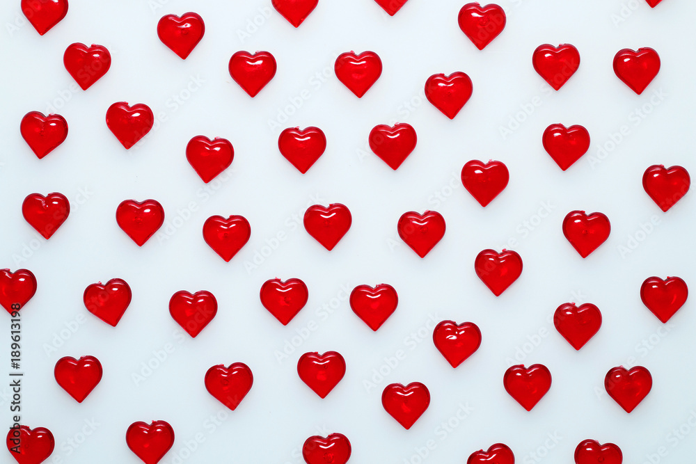 Background for St. Valentine's Day.
Decorative red hearts on a white background