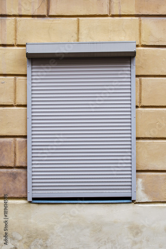 window with blinds on the brick wall