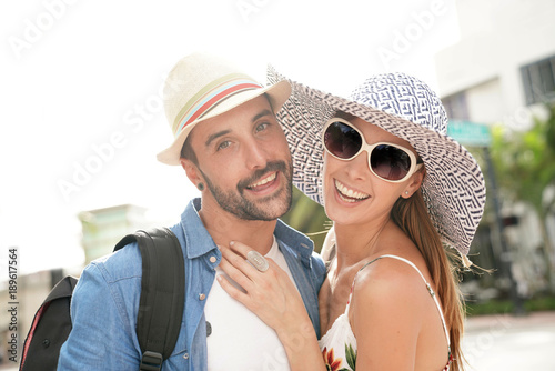 Portrait of happy couple on vacation wearing hats