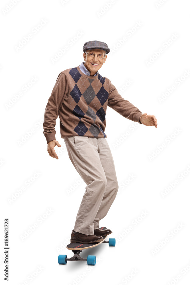 Senior riding a longboard and smiling Senior riding a longboard and smiling