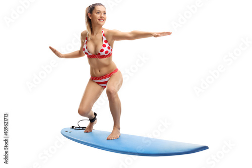 Young woman in bikini surfing