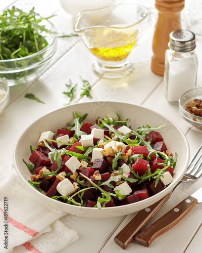 Healthy beet salad with cheese and herb for lunch on white table.