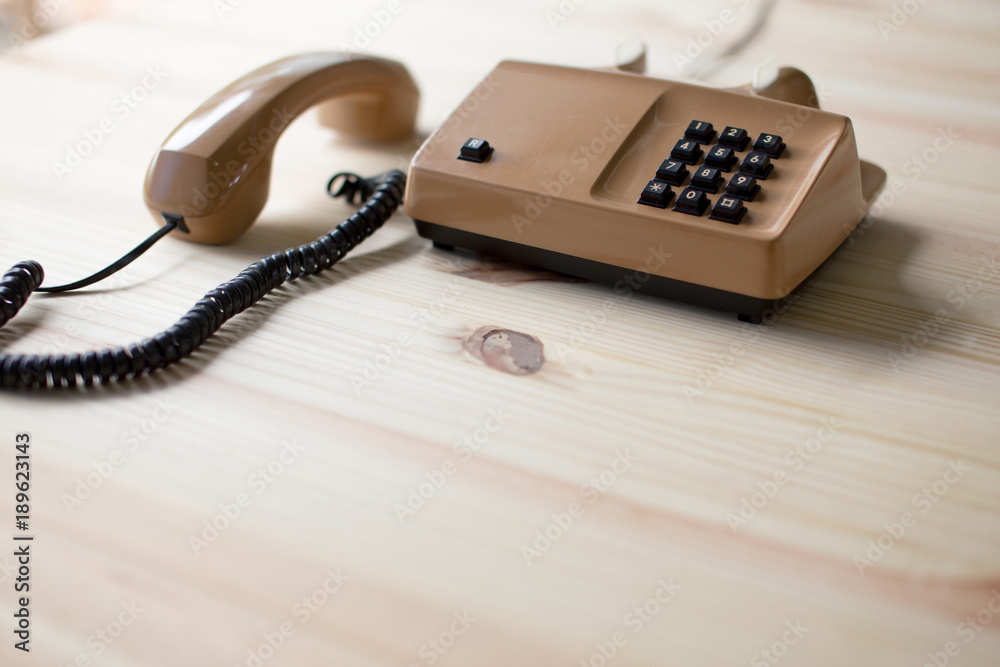 restro phone on pine wood table blank space under