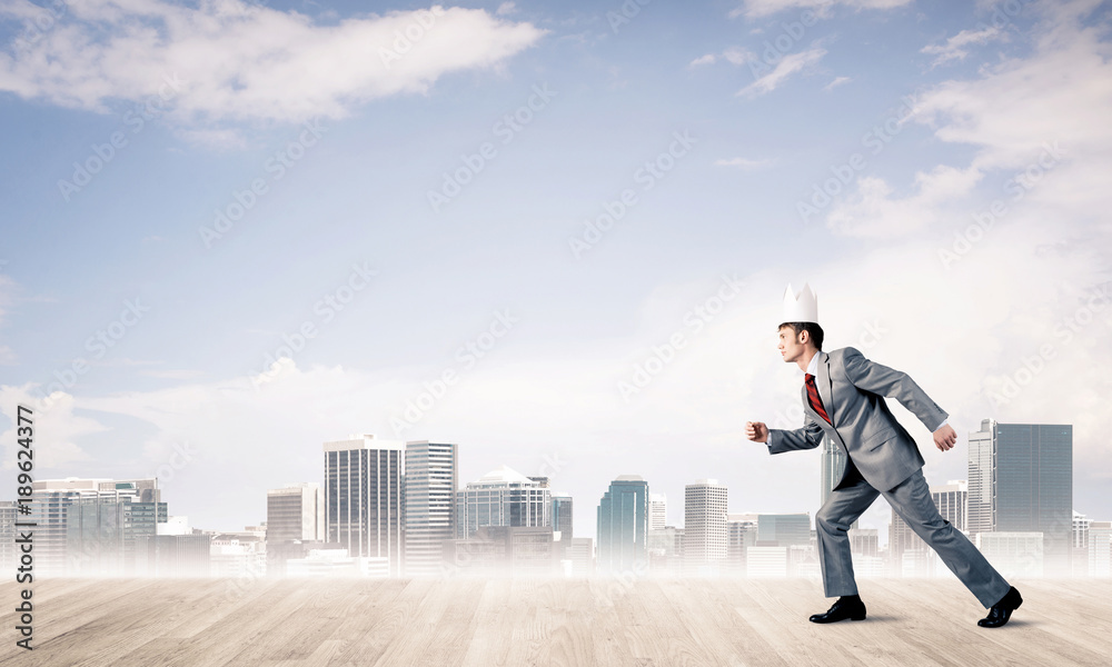 King businessman in elegant suit running and modern cityscape at King businessman in elegant suit running and modern cityscape at