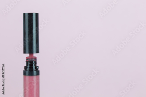 Old lipstick open black cap on pink background isolated with clipping path copyspace.