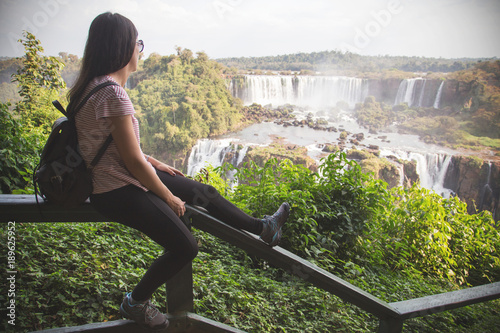 Woman looking at Iguazu Falls