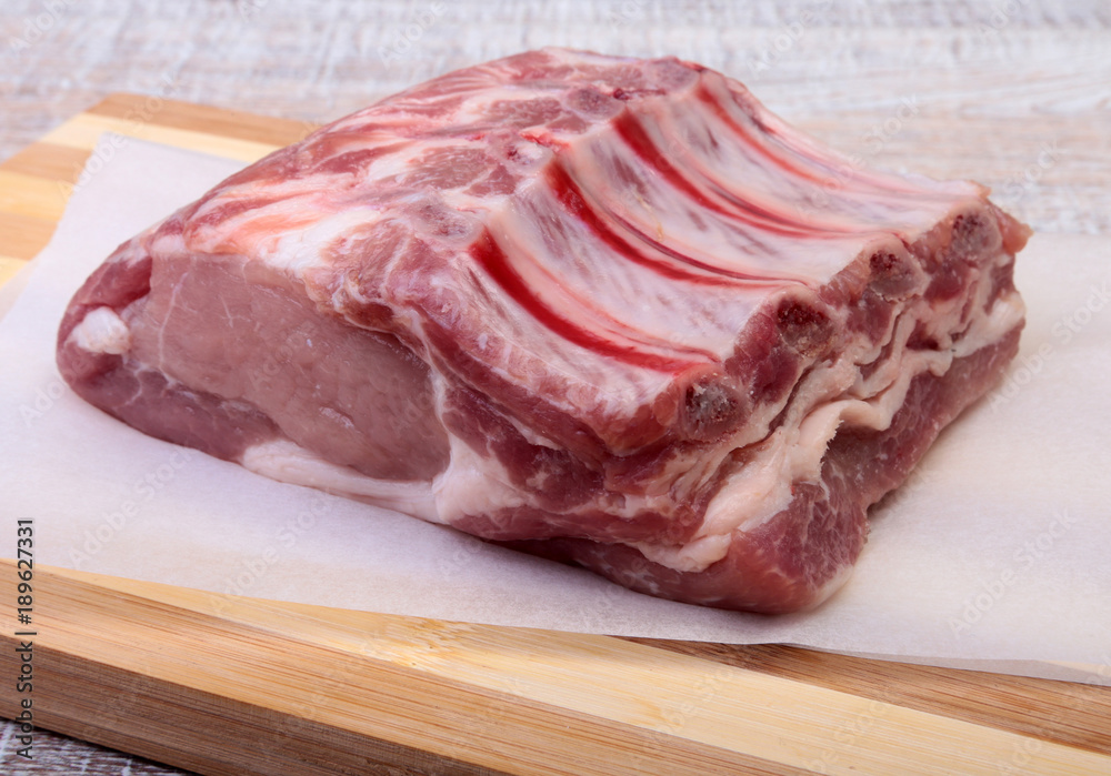 Raw pork chops, spices on cutting board. Ready for cooking. Raw pork chops, spices on cutting board. Ready for cooking.