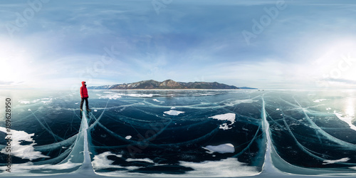 Man in blue hummocks of ice Baikal at sunset at Olkhon. Spherical vr 360 180 degrees panorama photo