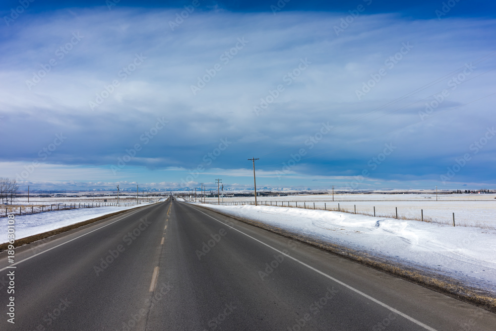 Alberta Rural Road with Mountains in the Horizon