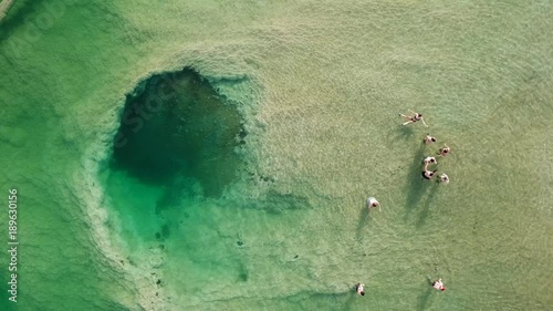 Top down aerial footage of people floating in the salty water of the Dead Sea, Israel.
