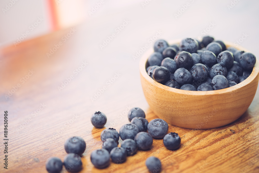 Freshly picked blueberries in wooden bowl.Bilberry on wooden Background. Blueberry antioxidant.Concept for healthy eating and nutrition. Freshly picked blueberries in wooden bowl.Bilberry on wooden Background. Blueberry antioxidant.Concept for healthy eating and nutrition.