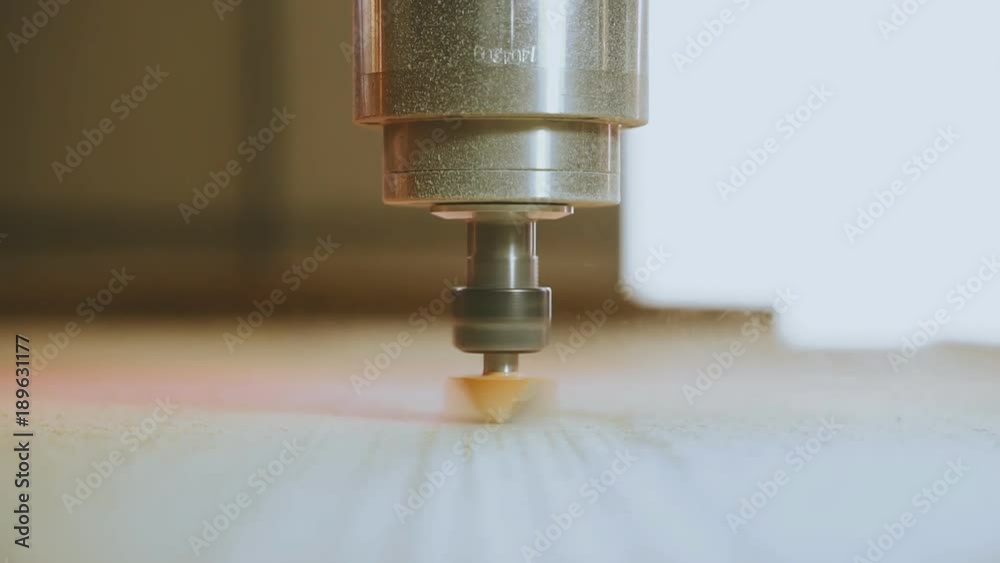 CNC machine. Movement of spindle and a milling cutter from the observer. You see small swarf from the milling. CNC machine. Movement of spindle and a milling cutter from the observer. You see small swarf from the milling.