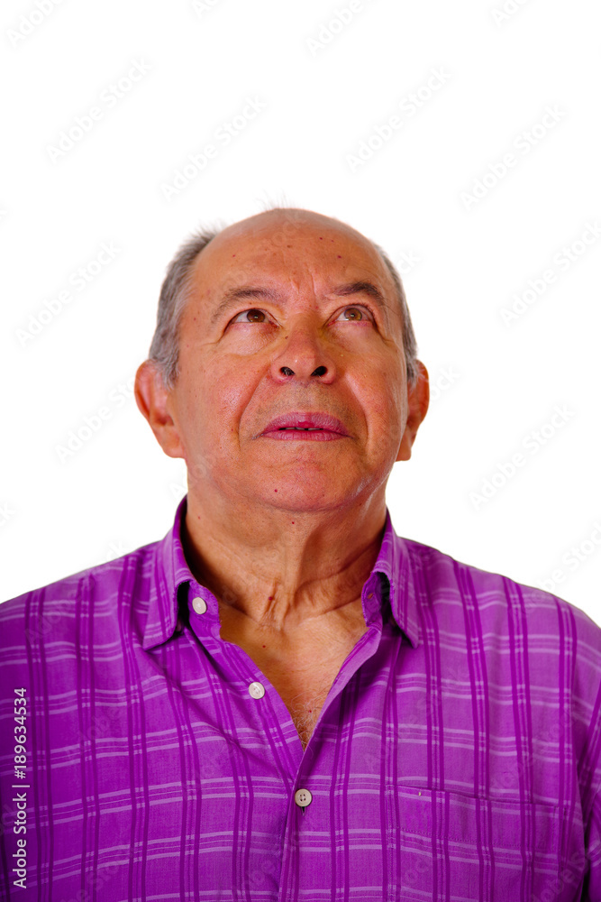 Portrait of a happy mature man wearing a purple square t-shirt in a blurred background Portrait of a happy mature man wearing a purple square t-shirt in a blurred background