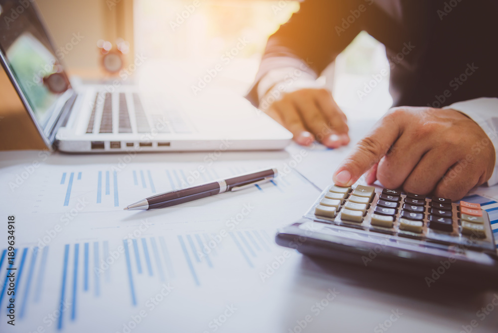business man financial inspector and secretary making report, calculating or checking balance. Internal Revenue Service inspector checking document. Audit concept. business man financial inspector and secretary making report, calculating or checking balance. Internal Revenue Service inspector checking document. Audit concept.