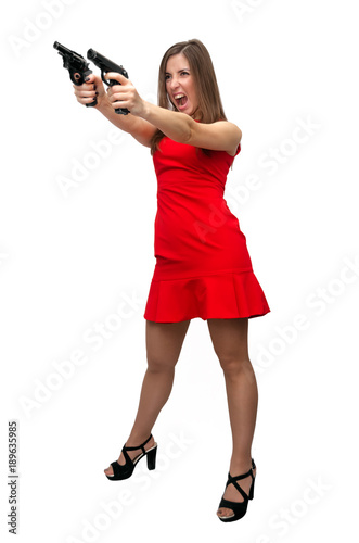 The spy. Special agent girl. Secret service. Dangerous sexy woman in red dress in stockings and high heels shoes is holding gun in her hands isolated on white.