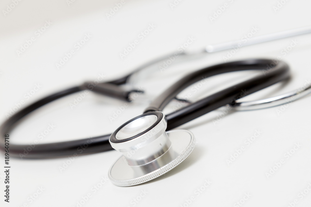 Stethoscope on table. Isolated on white background. Studio lighting. Concept for healthy and medical Stethoscope on table. Isolated on white background. Studio lighting. Concept for healthy and medical