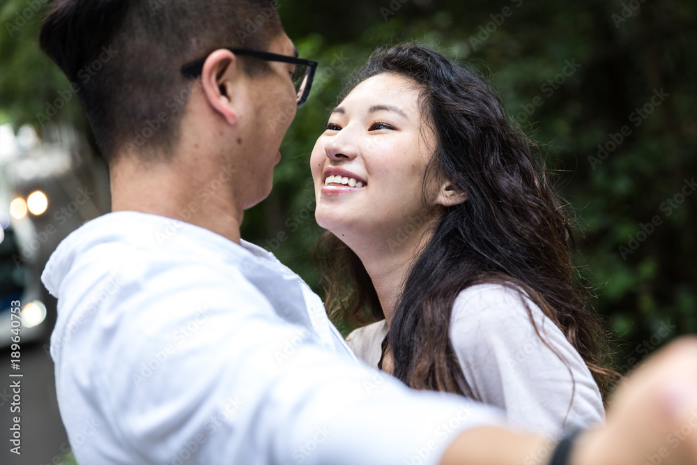 Asian Couple Taking a Selfie in the Park Asian Couple Taking a Selfie in the Park