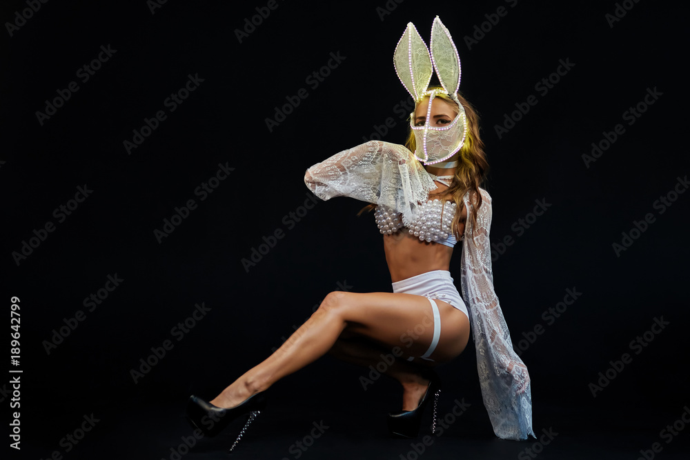 Sexy girl in white lingerie and LED mask. Go-go dancer. Stripper in the  studio on a black background. A girl from the show ballet in the night club  Stock-Foto | Adobe Stock