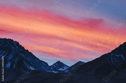 Colorful Sunset over Snowy Silhouetted Mountains