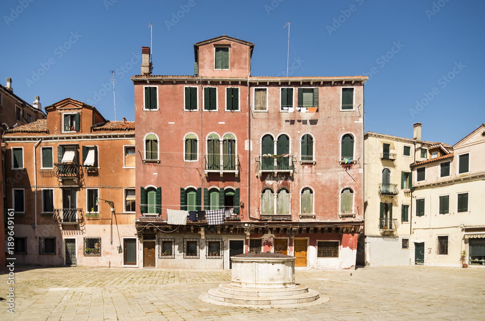 Old Venice square with a well