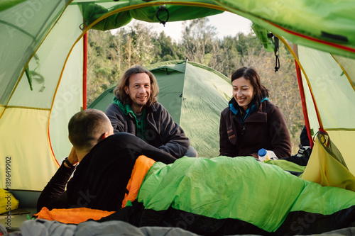 Friends travel and camping together in wild nature, smile and bo