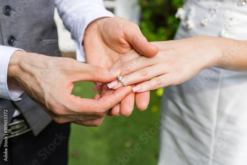 Groom wear a ring to bride in wedding day. © Worapoj