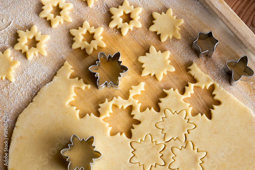 Preparation of Linzer Christmas cookies - cutting out star shapes photo