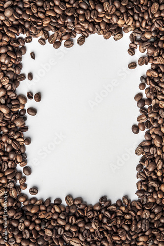 A vertical frame made of coffee in beans with a white background for the text in the middle.
