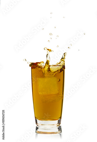 Cola with splash of ice cubes, isolated on white background.