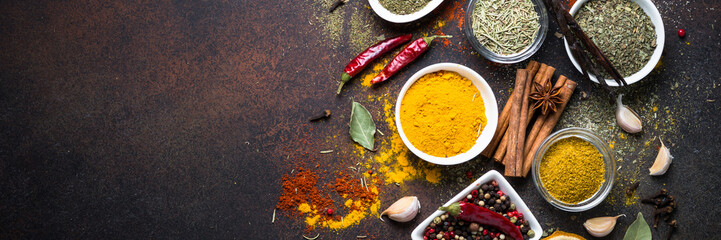 Set of Various spices on dark stone table.