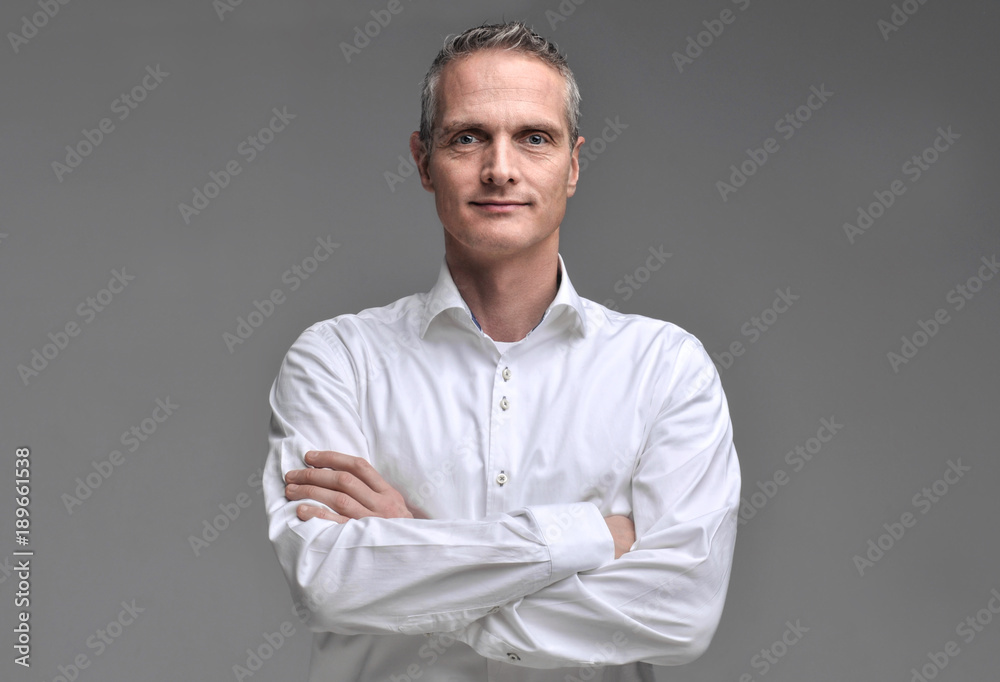 Portrait of a man in a shirt on a gray background. Portrait of a man in a shirt on a gray background.
