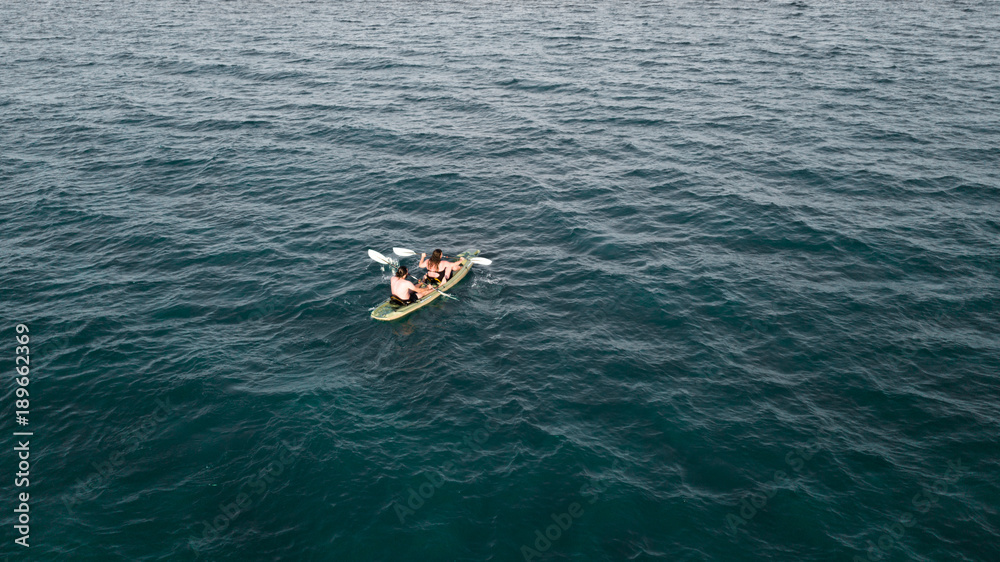 Aerial view of two kayaker peddling on the sea . drone view of two people kayaking