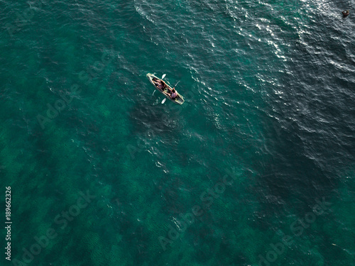 Aerial view of two kayaker peddling on the sea . drone view of two people kayaking