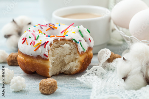 Donuts with icing on a white table, white eggs, Easter concept Menu, restaurant recipe concept Served in