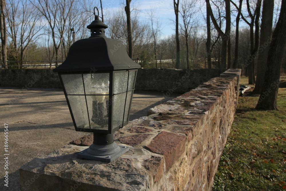The antique light on the stone wall.