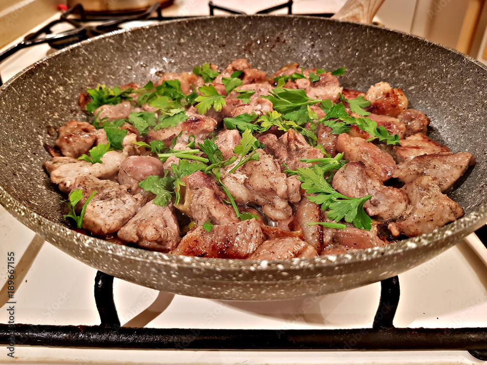 Finely chopped pieces of pork with onion and spices fry in oil on the stove
Finely chopped pieces of pork with onion and spices fry in oil on the stove