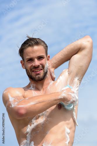 Male body with sexy strong torso. Guy covered with foam