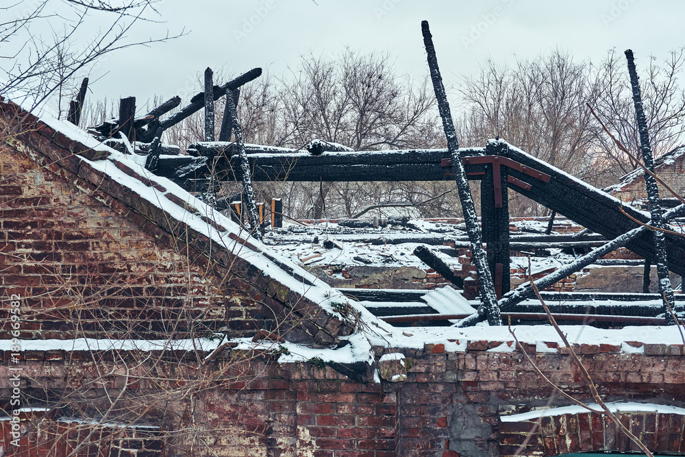 After the fire, a brick wall and charred wooden floors remained from the house After the fire, a brick wall and charred wooden floors remained from the house