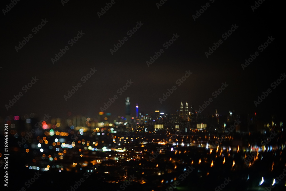 Blurred dramatic night view of city with abstract of LED, neon lights and beautiful bokeh.