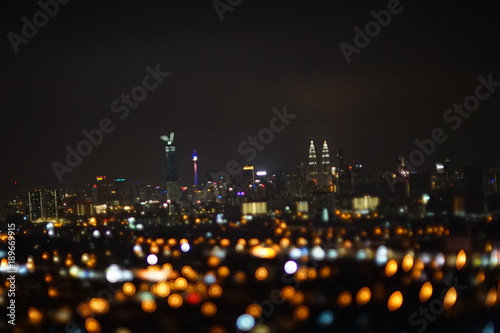 Blurred dramatic night view of city with abstract of LED, neon lights and beautiful bokeh. © fiqah
