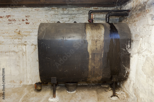 Fotografija Old heating oil tank in dingy dank basement.