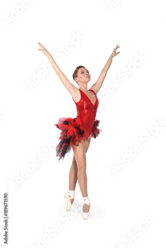 the ballerina in pointes and a red dress dances on a white background