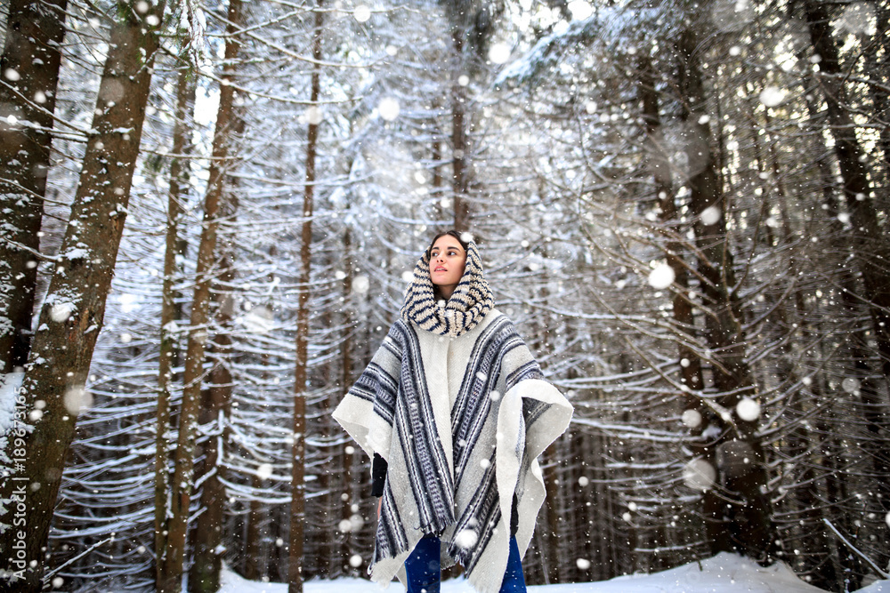 Young woman winter portrait. Happy young woman walking in winter forest. Happy girl having fun in the snow. Snow covered trees in the winter sun light. Snowy pine trees on a winter landscape Young woman winter portrait. Happy young woman walking in winter forest. Happy girl having fun in the snow. Snow covered trees in the winter sun light. Snowy pine trees on a winter landscape