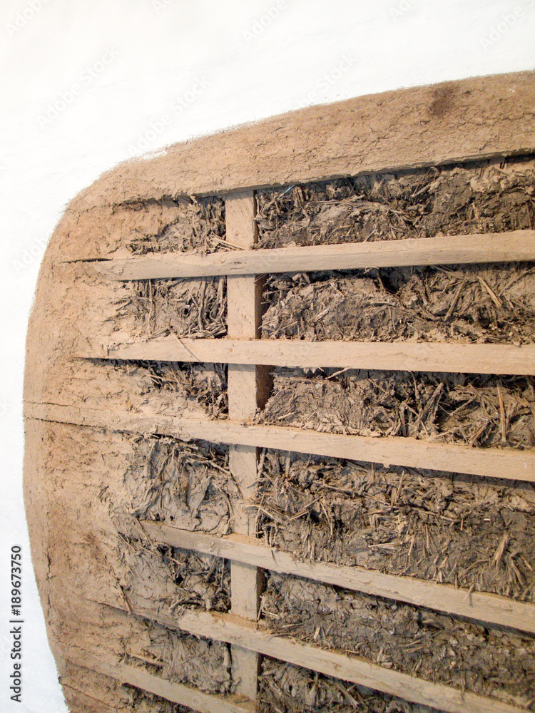 traditional house wall made with wood strips filled with a mix of clay and straw old way of