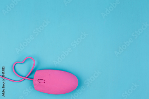 Love chat, online dating. Pink computer mouse with heart shaped wire. Love, Valentine, internet concept